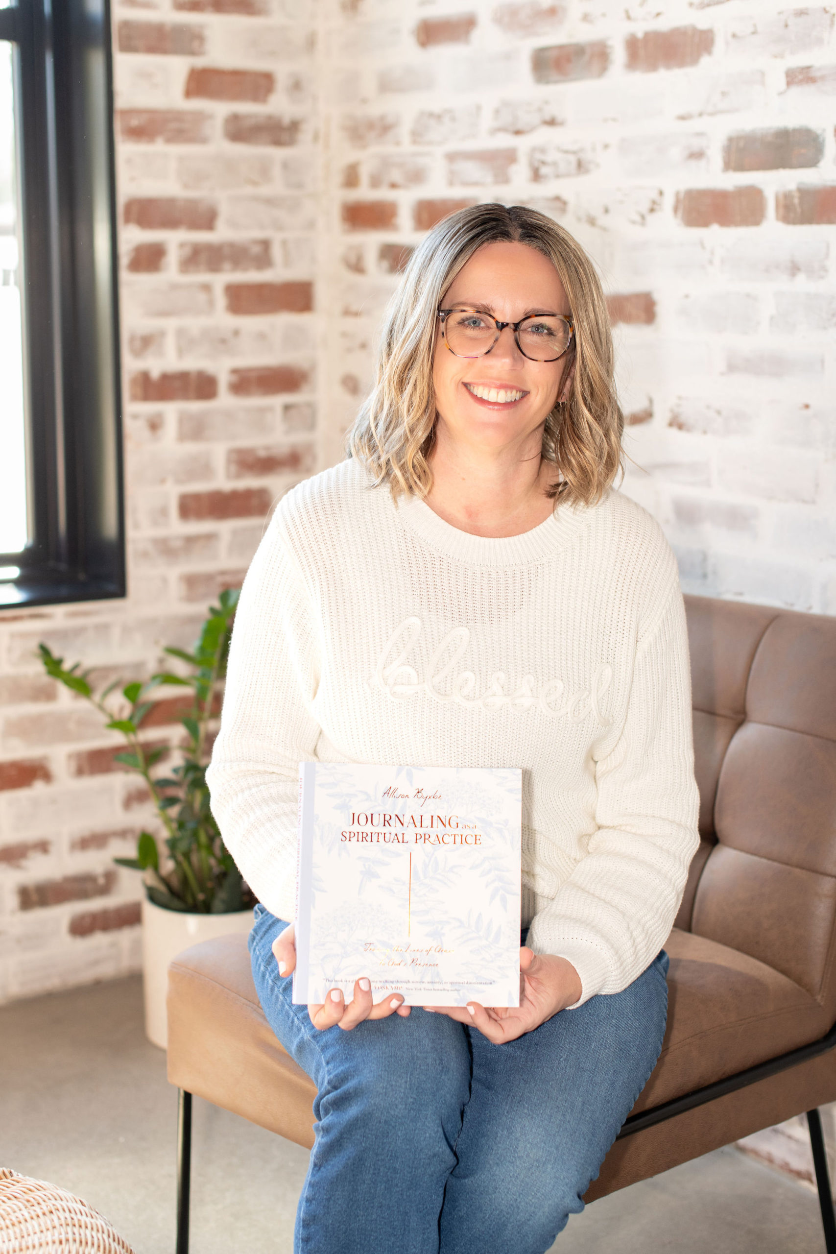 Allison Byxbe holding Journaling as a Spiritual Practice book